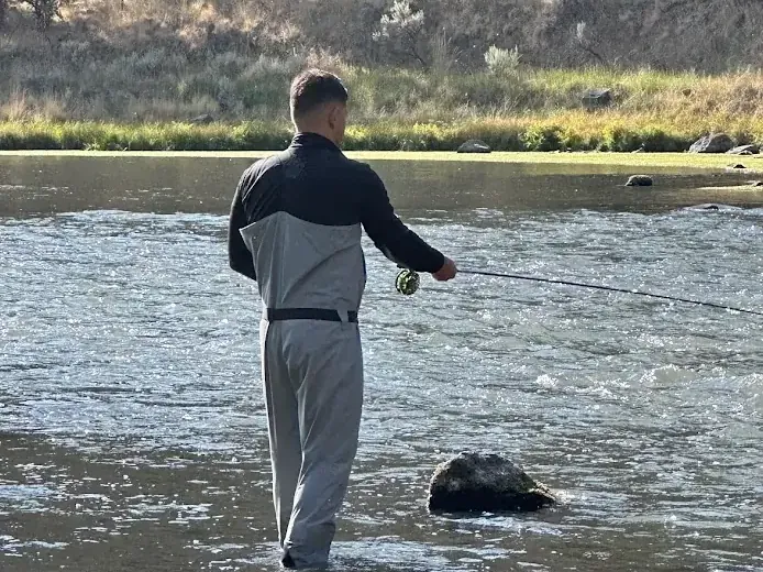 A fly fisherman wading in a Central Oregon river