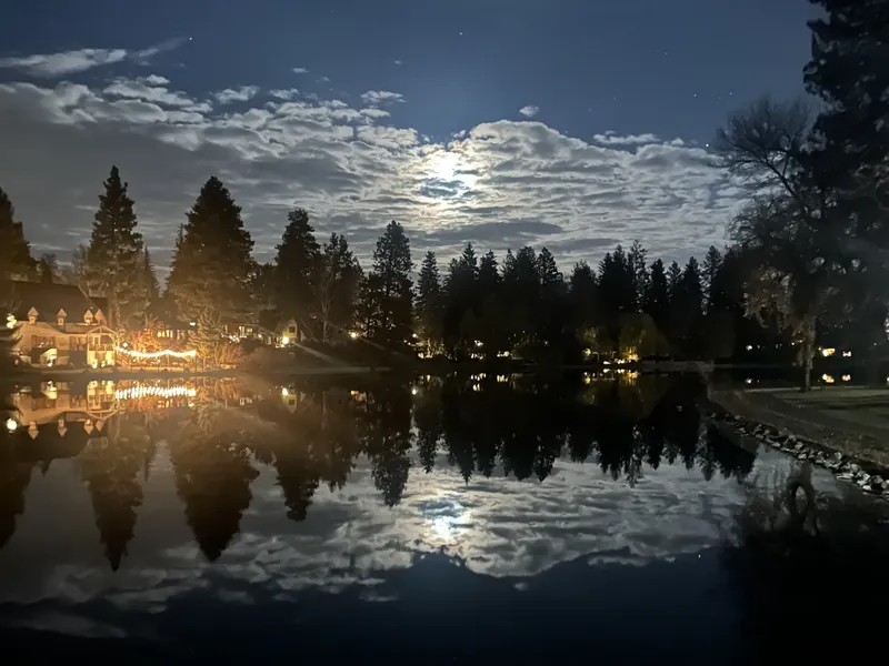 A full moon over Mirror Pond in Bend at night