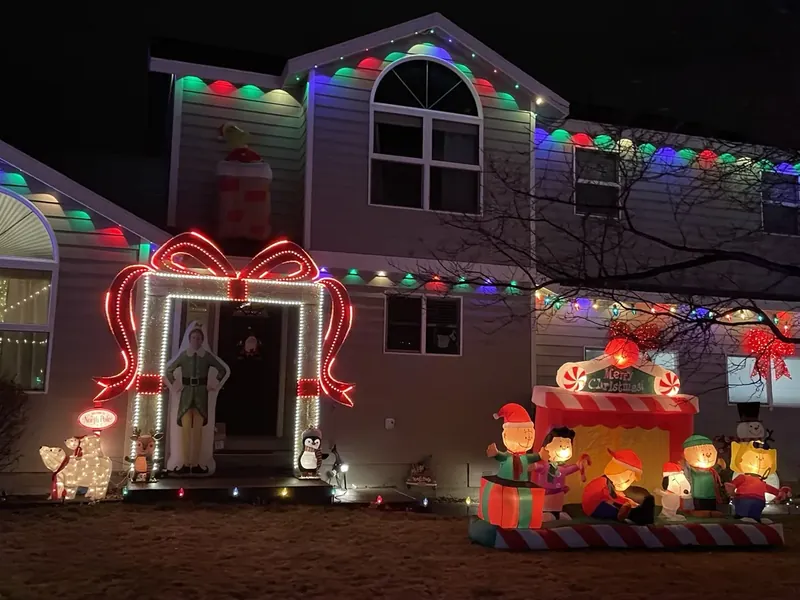 A Bend home covered in colorful Christmas lights and yard decorations