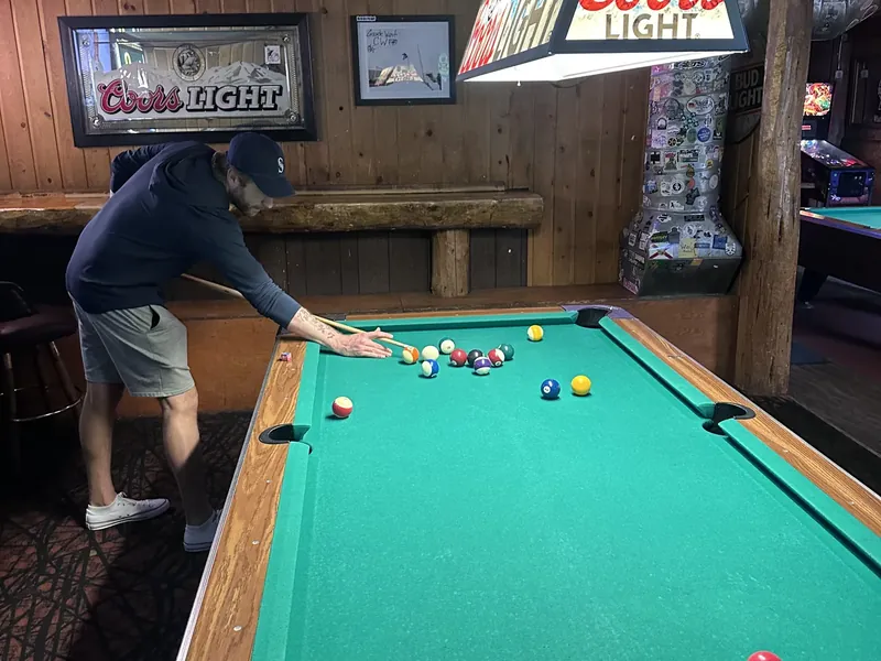 A pool table and beer signs inside a Bend bar