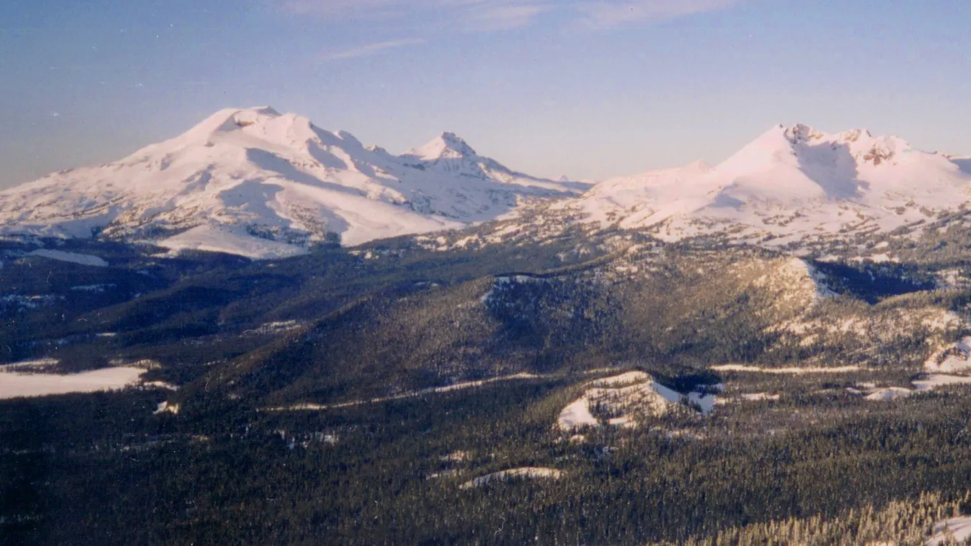 The snowy Three Sisters and Broken Top above miles of pine forest west of Bend