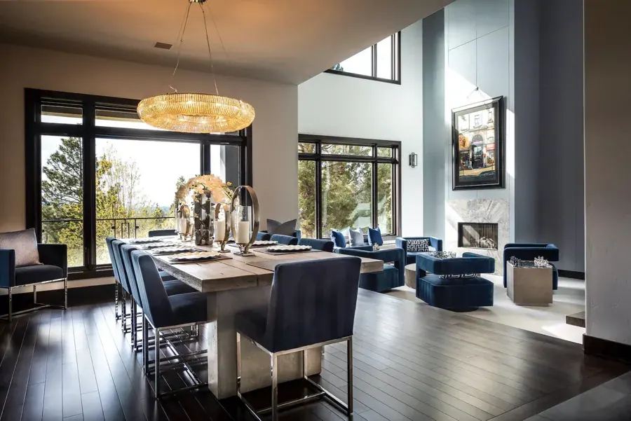 A two-story dining room with tall windows by FUSE Design + Build in Bend