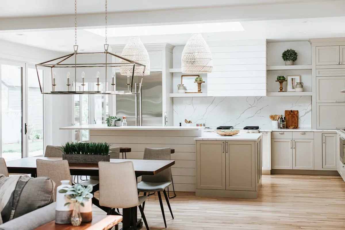 White kitchen with a lantern chandelier designed by Emily Cathcart