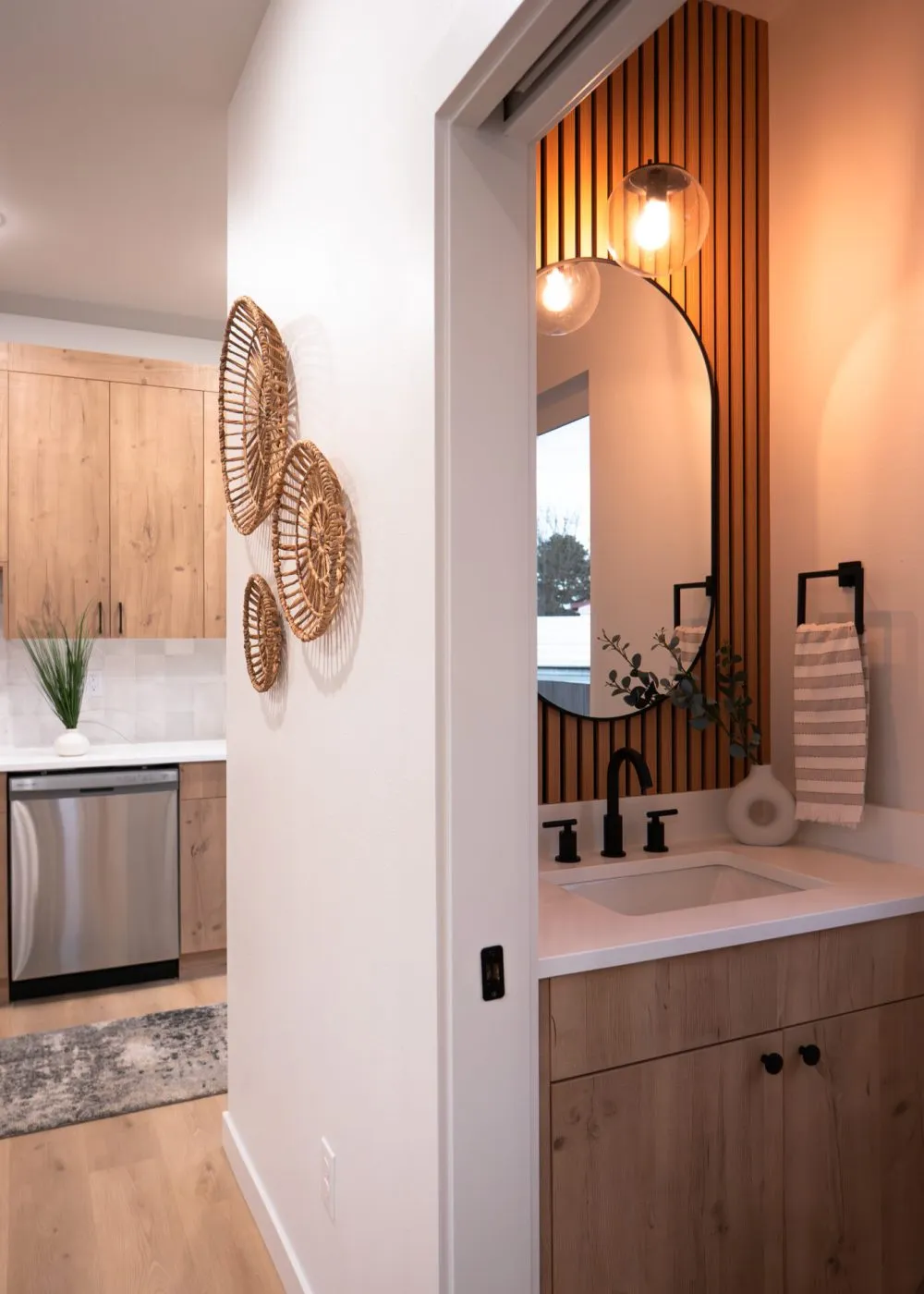 Light wood kitchen with an island and stools by Harris & Sons