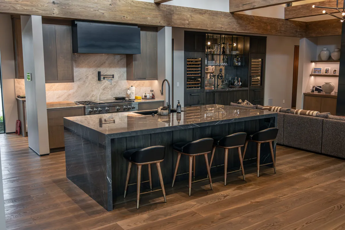 Dark stone island in a wood kitchen by Imagine Stoneworks