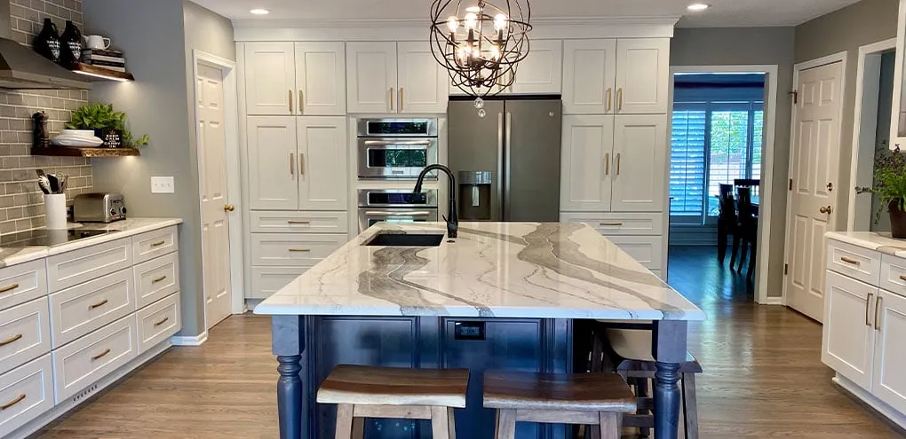 White painted kitchen with a marble island after a Kitchen Tune-Up update