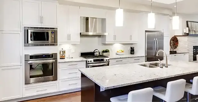 Refinished white kitchen cabinets with a granite island by N-Hance