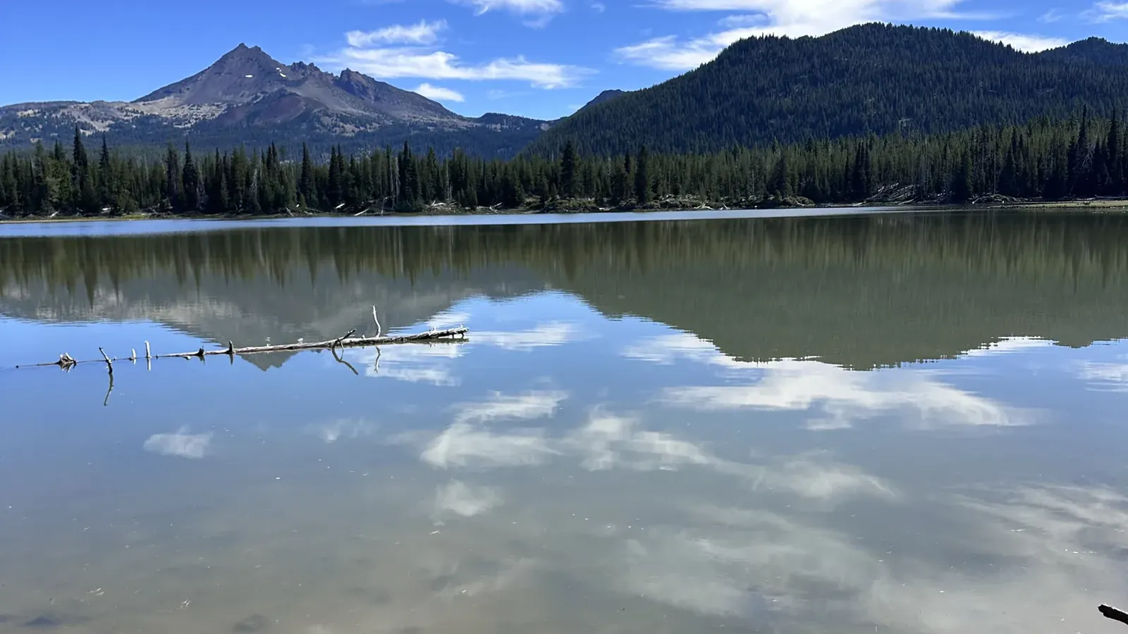 Cascade mountains reflected in a still lake west of Bend