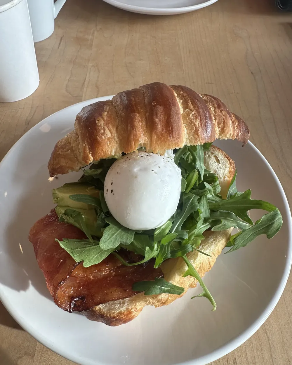 A croissant breakfast sandwich to go in Bend