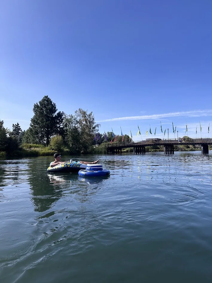 Floaters on the Deschutes River heading into the Old Mill District
