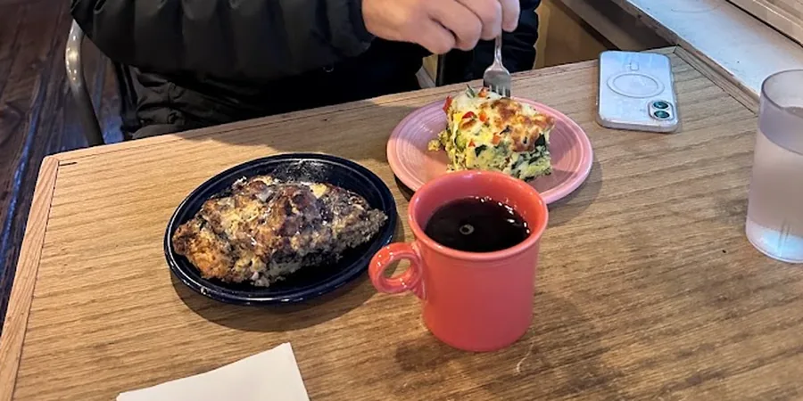 Quiche, a savory pastry and a mug of coffee on a table at Nancy P's Cafe & Bakery in Bend, Oregon