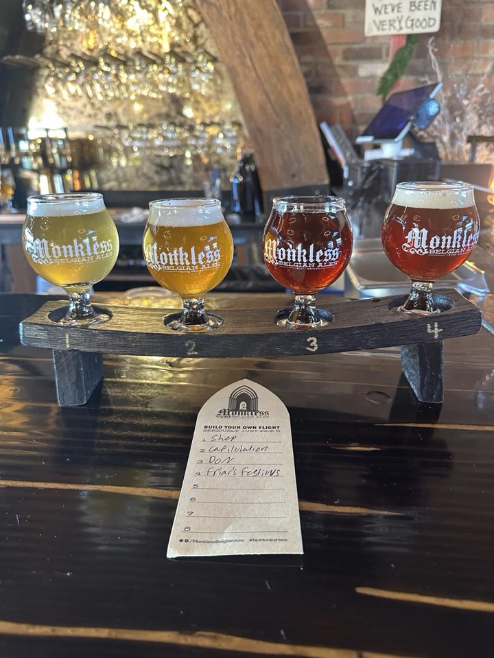 A four-beer tasting flight with a handwritten order slip at a Bend taproom