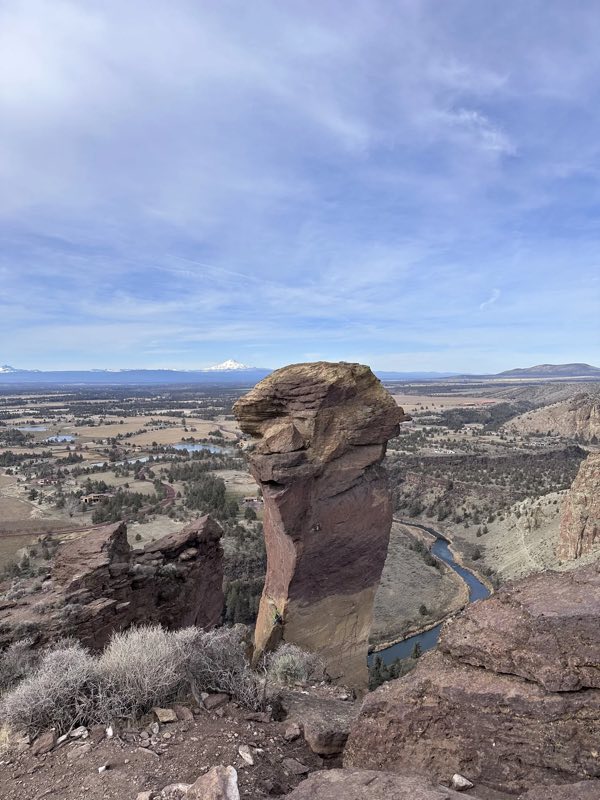 Monkey Face rock formation at Smith Rock with the Crooked River and Cascades behind