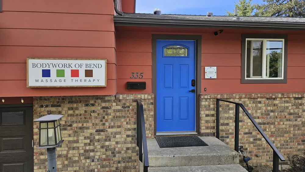 The blue front door of Bodywork of Bend on NE 4th Street