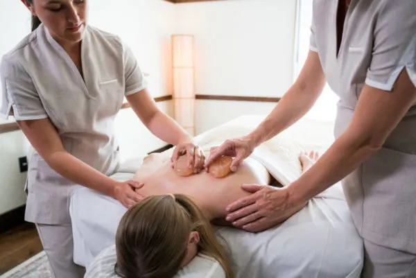 Two therapists performing a massage at Juniper Spa