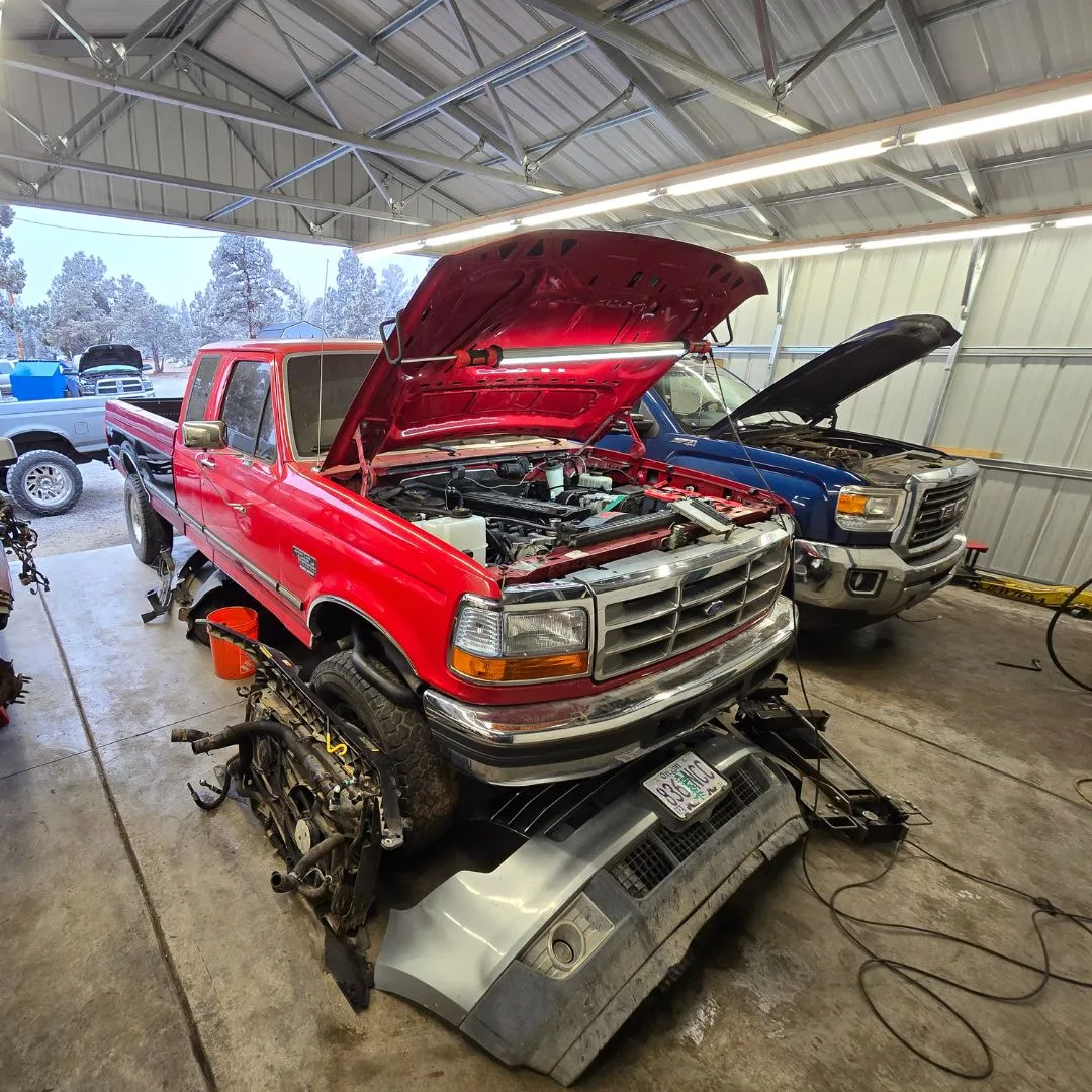 A red Ford diesel truck on the lift at Barrett Performance
