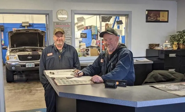 Two mechanics at the front counter of Brandy's Automotive in Bend