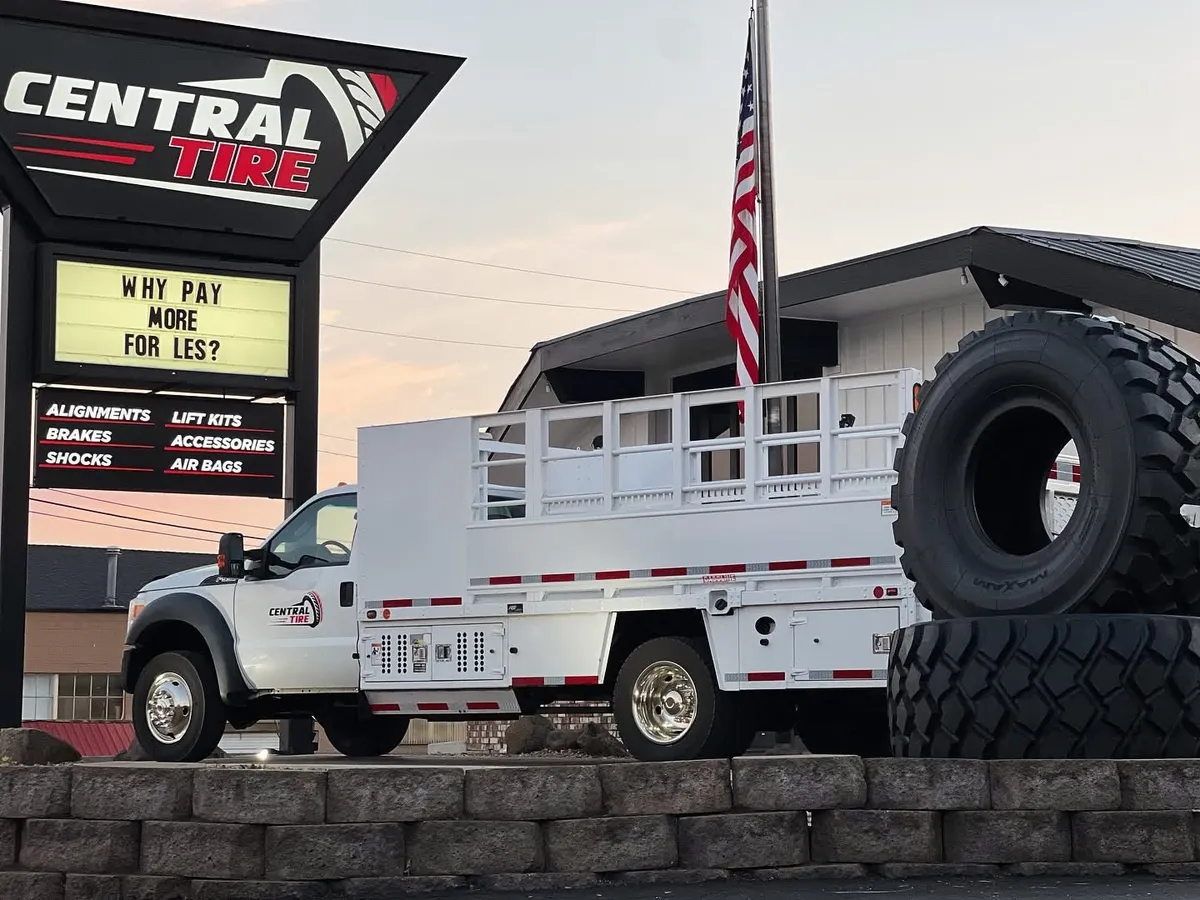 The Central Tire shop with a service truck and giant tire