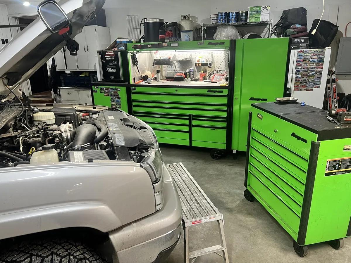 A pickup in the bay at Harmon's Wrench Worx with green toolboxes