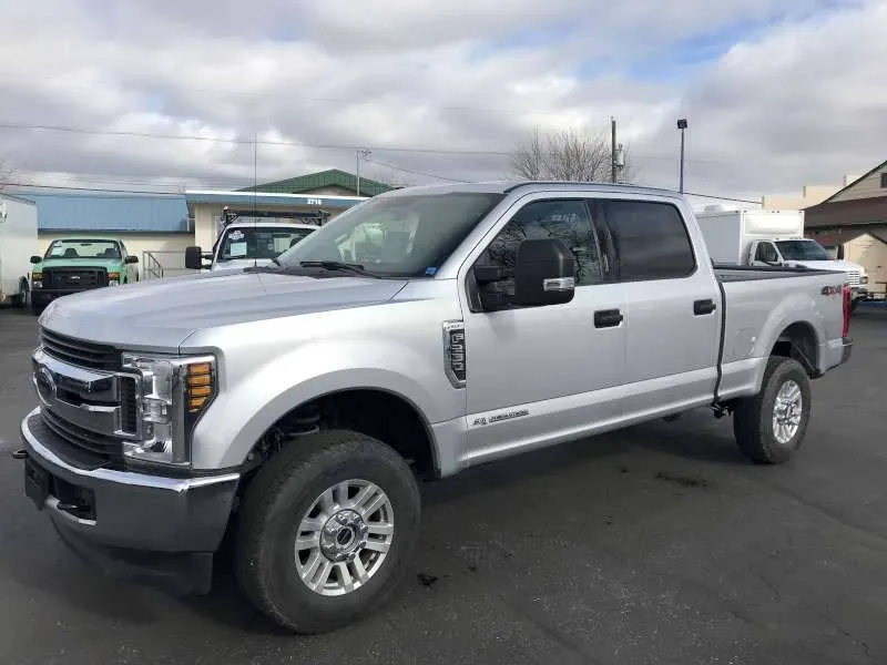 A silver Ford Super Duty diesel truck