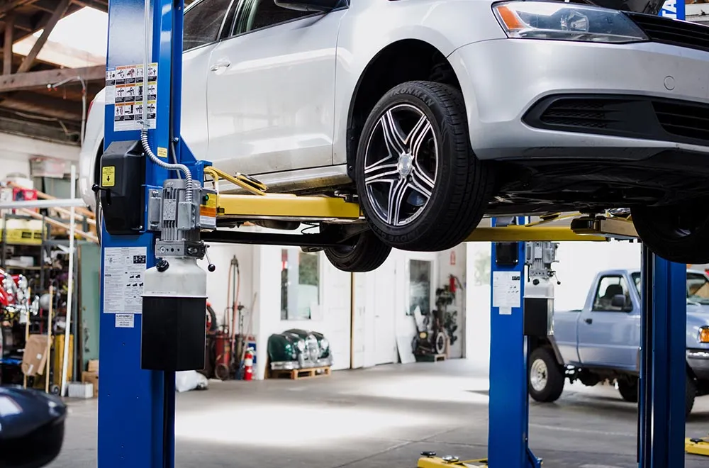 A car on a lift inside Marshalls Automotive in Redmond