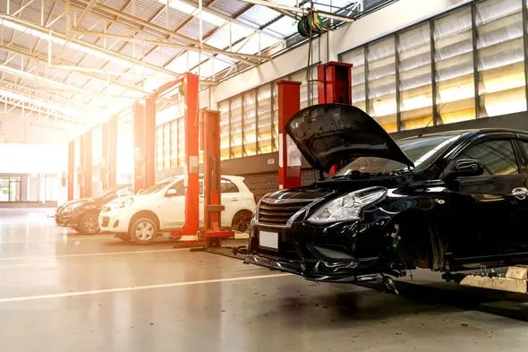 A busy auto repair shop with cars on lifts