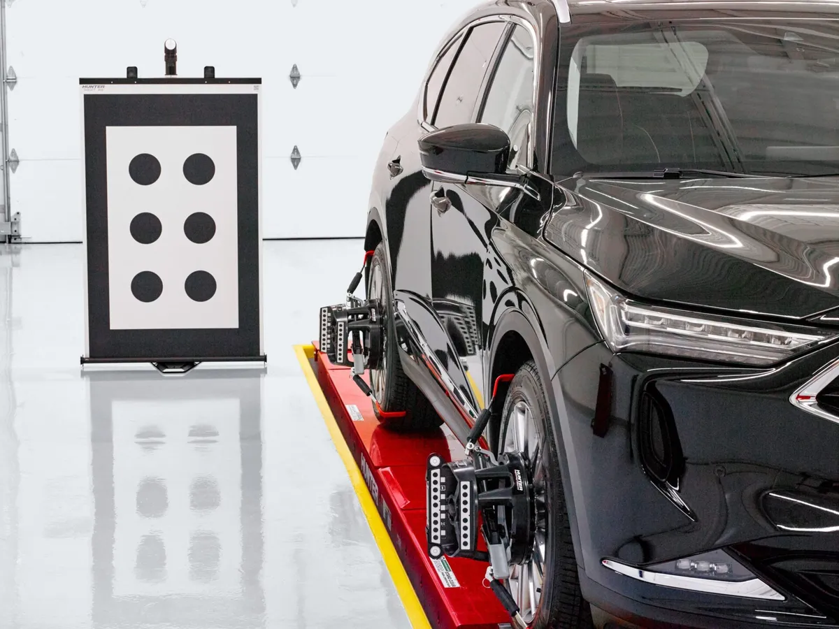 A car on an alignment rack at NW Wheel & Tire