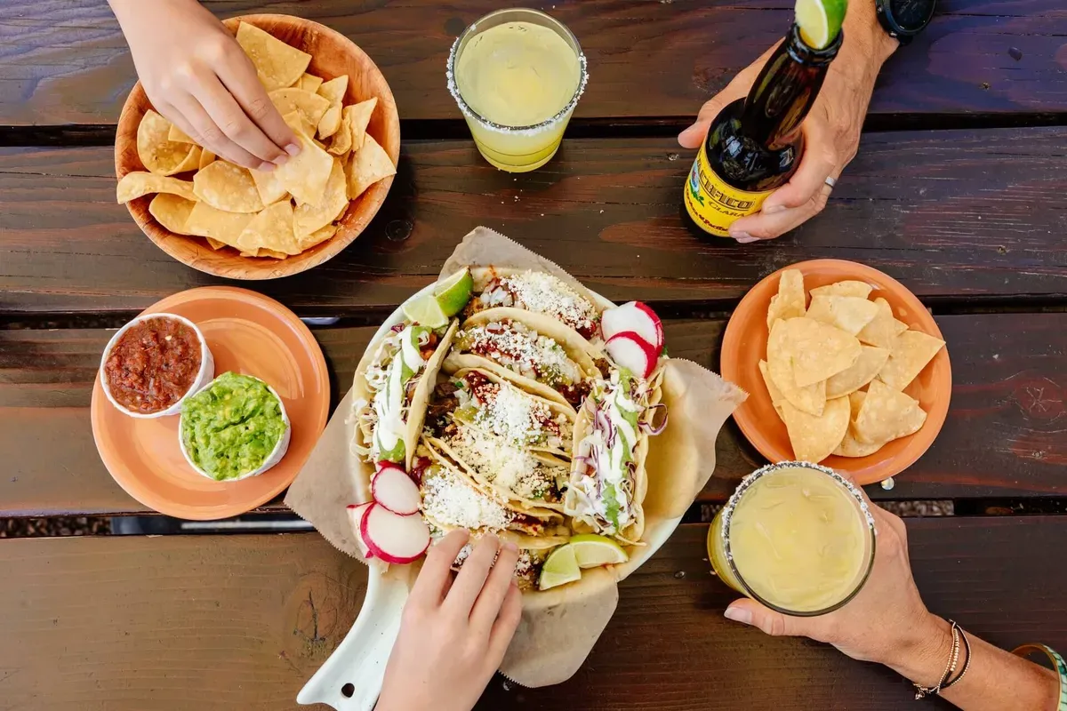 Tacos, chips, salsa, guacamole and margaritas on a wooden table in Central Oregon