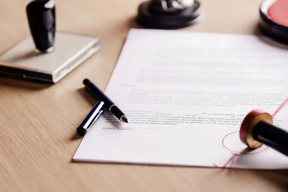Notary stamps and a pen on a signed document