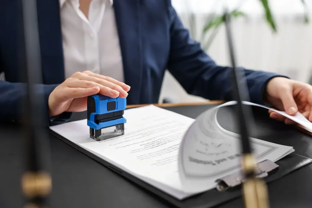 Notary pressing a stamp onto a document