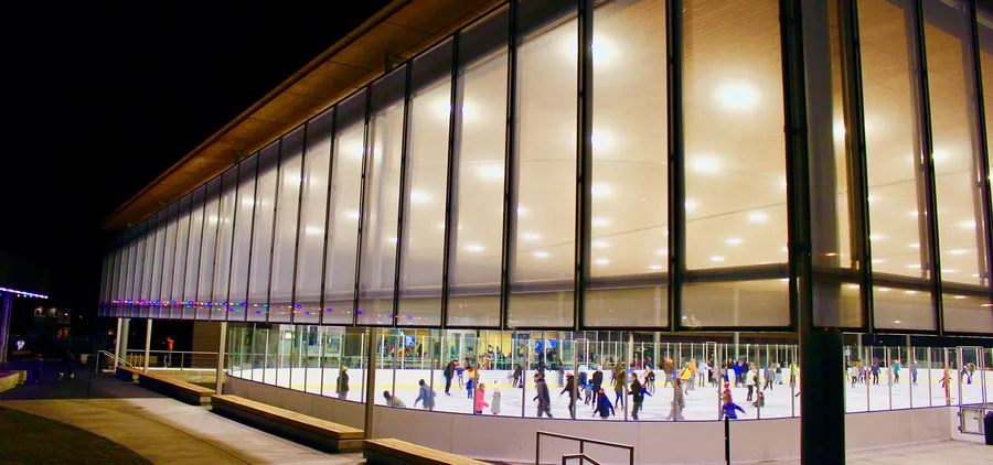 The covered ice rink at The Pavilion in Bend lit up at night