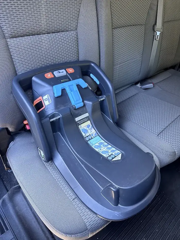 Infant car seat base installed on the back seat of a pickup truck in Bend, Oregon