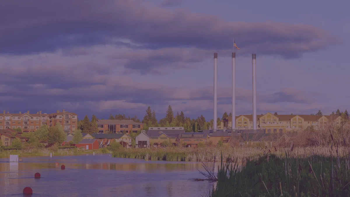 The Old Mill District smokestacks in Bend at dusk, from Aperion Management Group