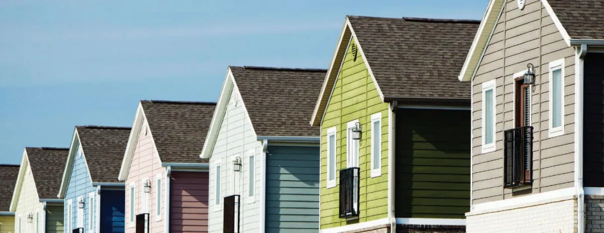 A row of colorful townhomes, from The Management Trust