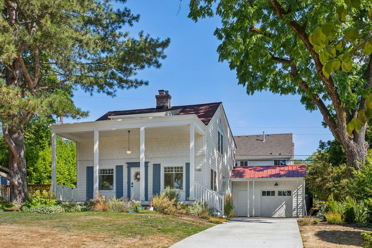 A white two-story rental home with a front porch, from North Star Property Management
