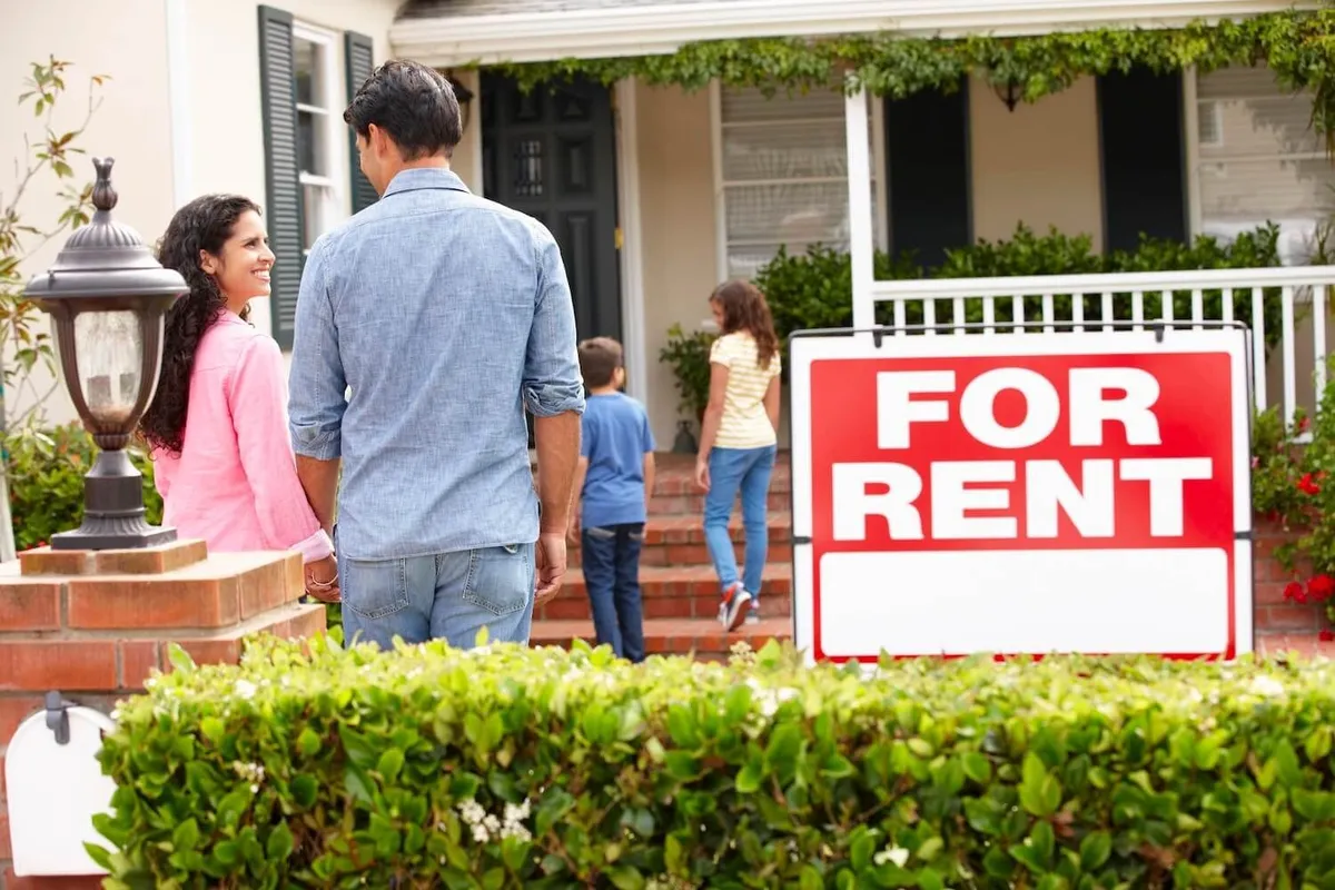A family outside a home with a For Rent sign, from Superior Property Management