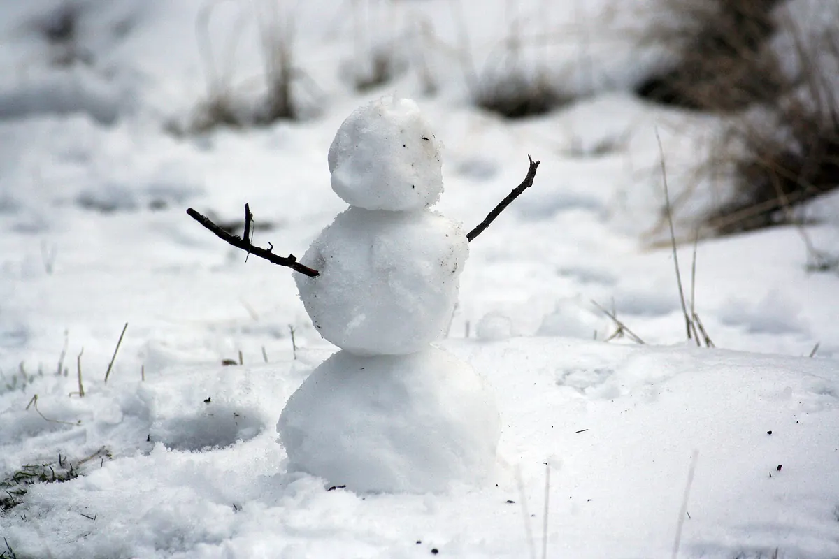 A small snowman in fresh snow in Bend