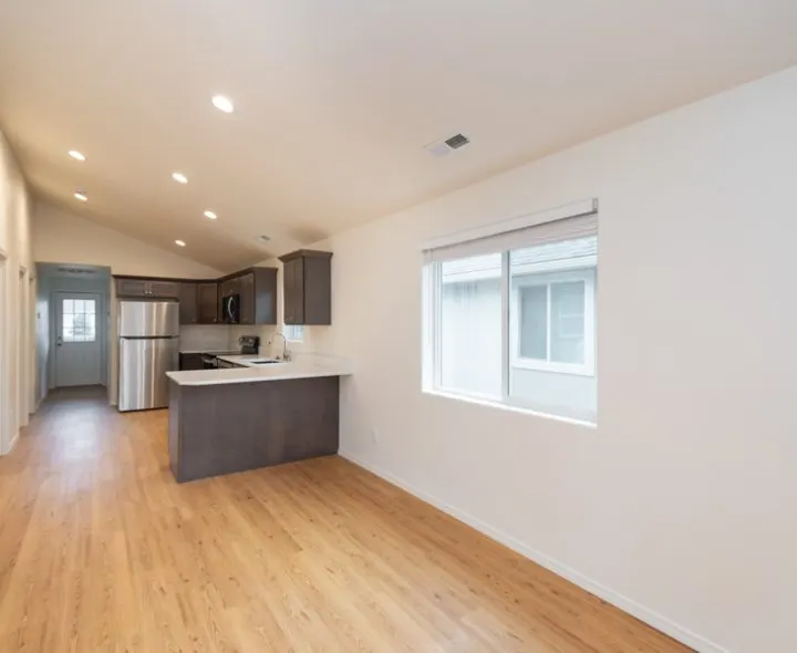 Bright remodeled kitchen and living area with vaulted ceiling by General Quality Services