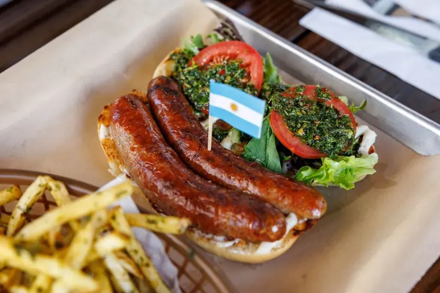 Two sausages with chimichurri on a roll and fries at Bangers & Brews in Bend