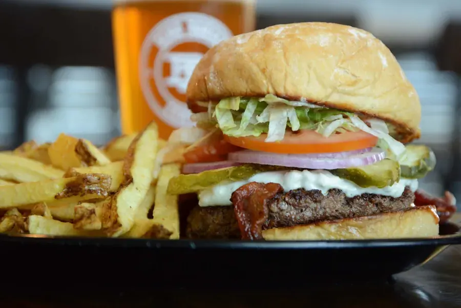 A loaded burger with fries and a pint at Bend Burger Company on 3rd Street