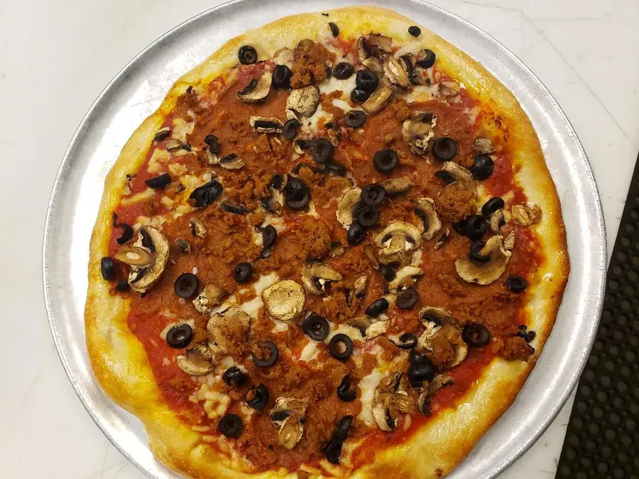 A hand-tossed pizza with mushrooms and olives at Bend Pizza Kitchen in NorthWest Crossing