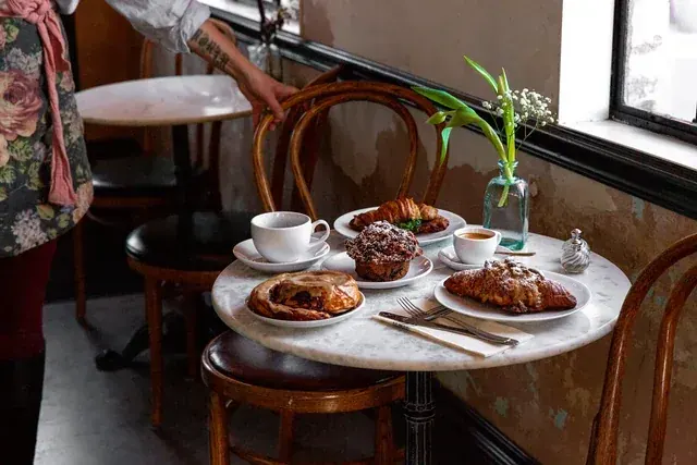 Pastries and coffee on a marble cafe table at Café des Chutes in Bend