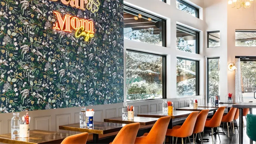 The dining room and floral Dear Mom wall at Dear Mom Cafe on Century Drive in Bend