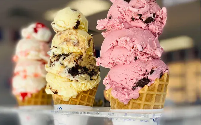 Three waffle cones piled with scoops at Handel’s Homemade Ice Cream