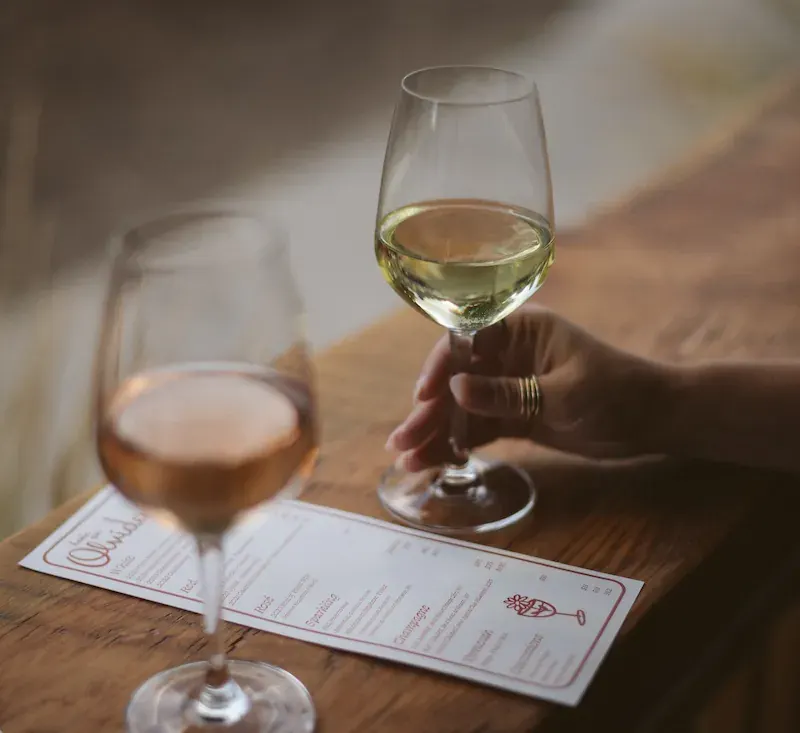 Two glasses of wine over the menu at Hasta Que Olvidemos on Galveston Avenue in Bend