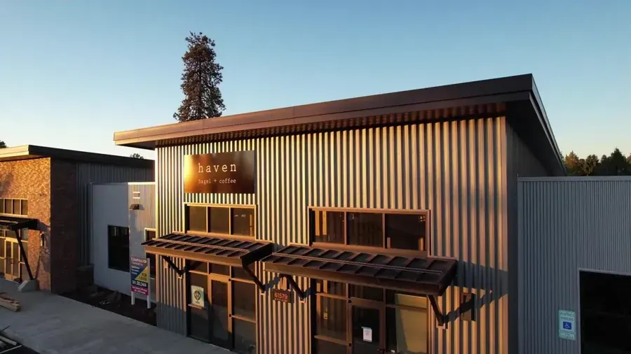The exterior of a Haven Bagel and Coffee shop in Bend at dusk