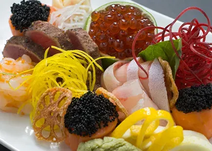 A chirashi plate of sashimi, roe and vegetables at Kanpai sushi bar in Bend