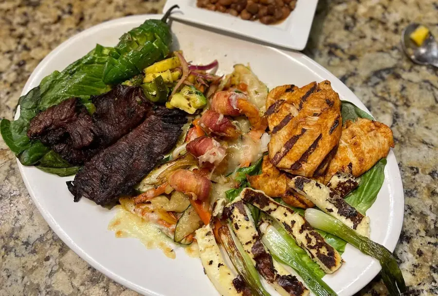 A plate of grilled steak, chicken and peppers at La Rosa in Bend