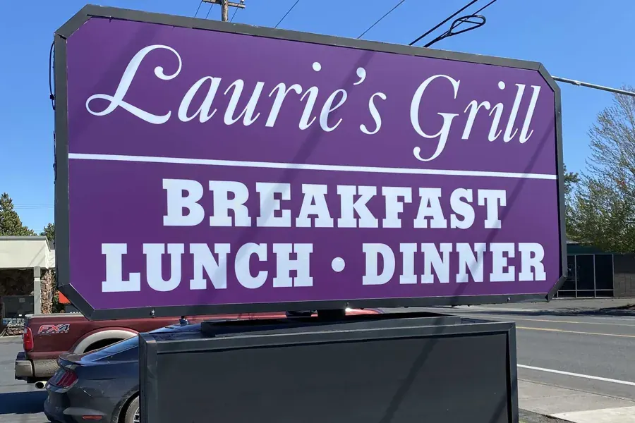 The purple roadside sign for Laurie’s Grill on NE 3rd Street in Bend
