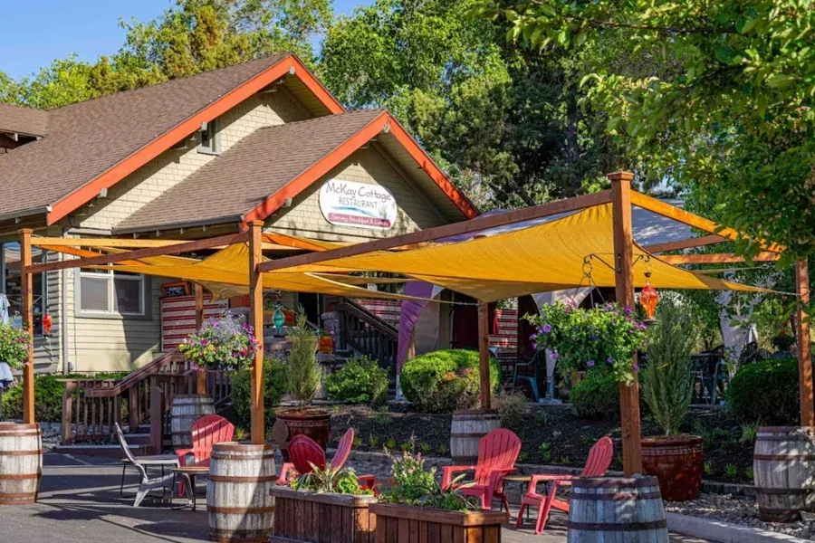 The patio under yellow shade sails in front of McKay Cottage restaurant in Bend